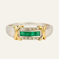 Two-tone 10k gold ring with a row of square-cut green emeralds framed by round diamonds, yellow gold X on each white gold shoulder