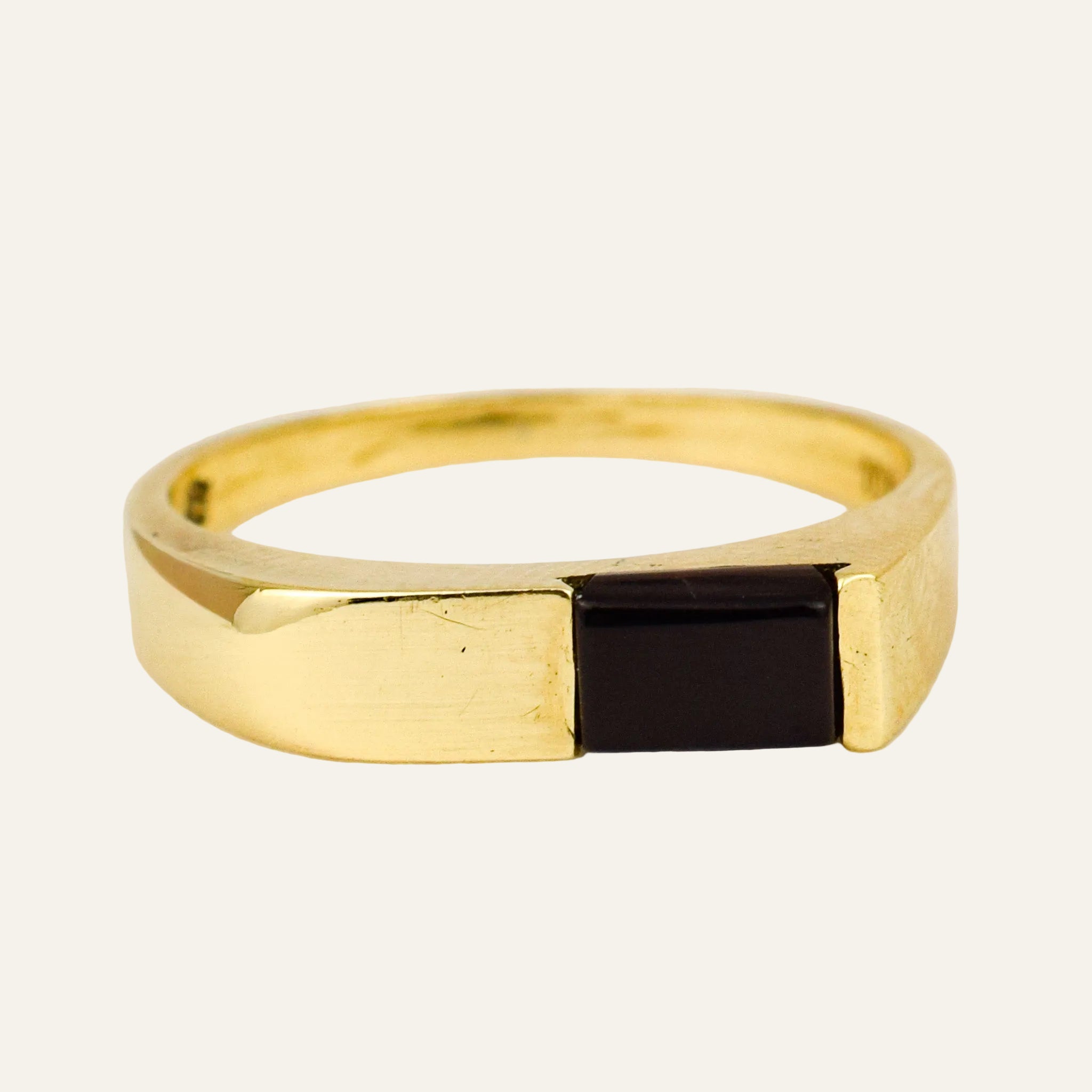 Slim 10k yellow gold band with a single rectangular black onyx set flush into the top