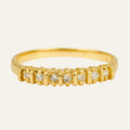 14k yellow gold band set with a row of seven small diamonds across the front, slim stacking band