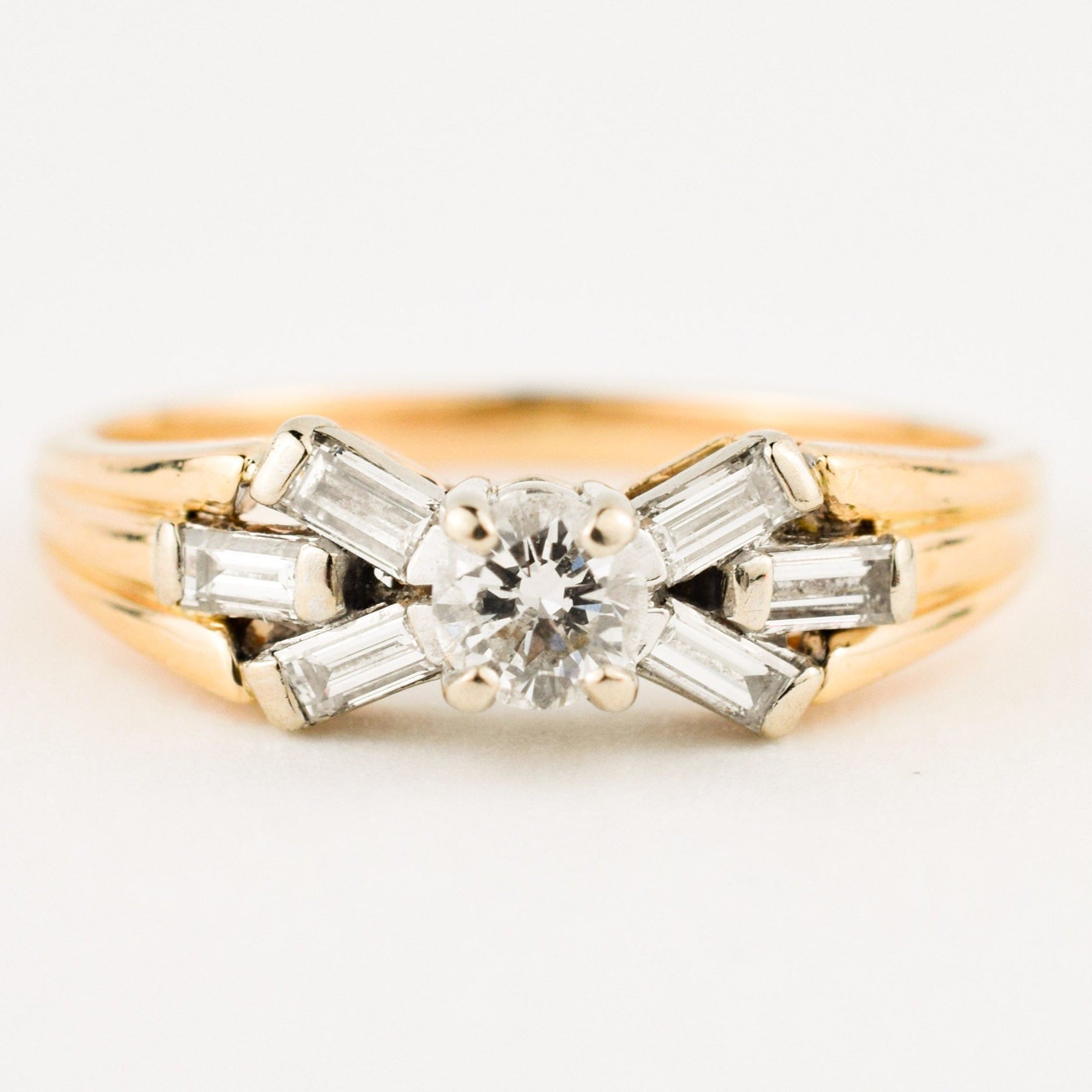 vintage engagement ring with baguette diamonds on band