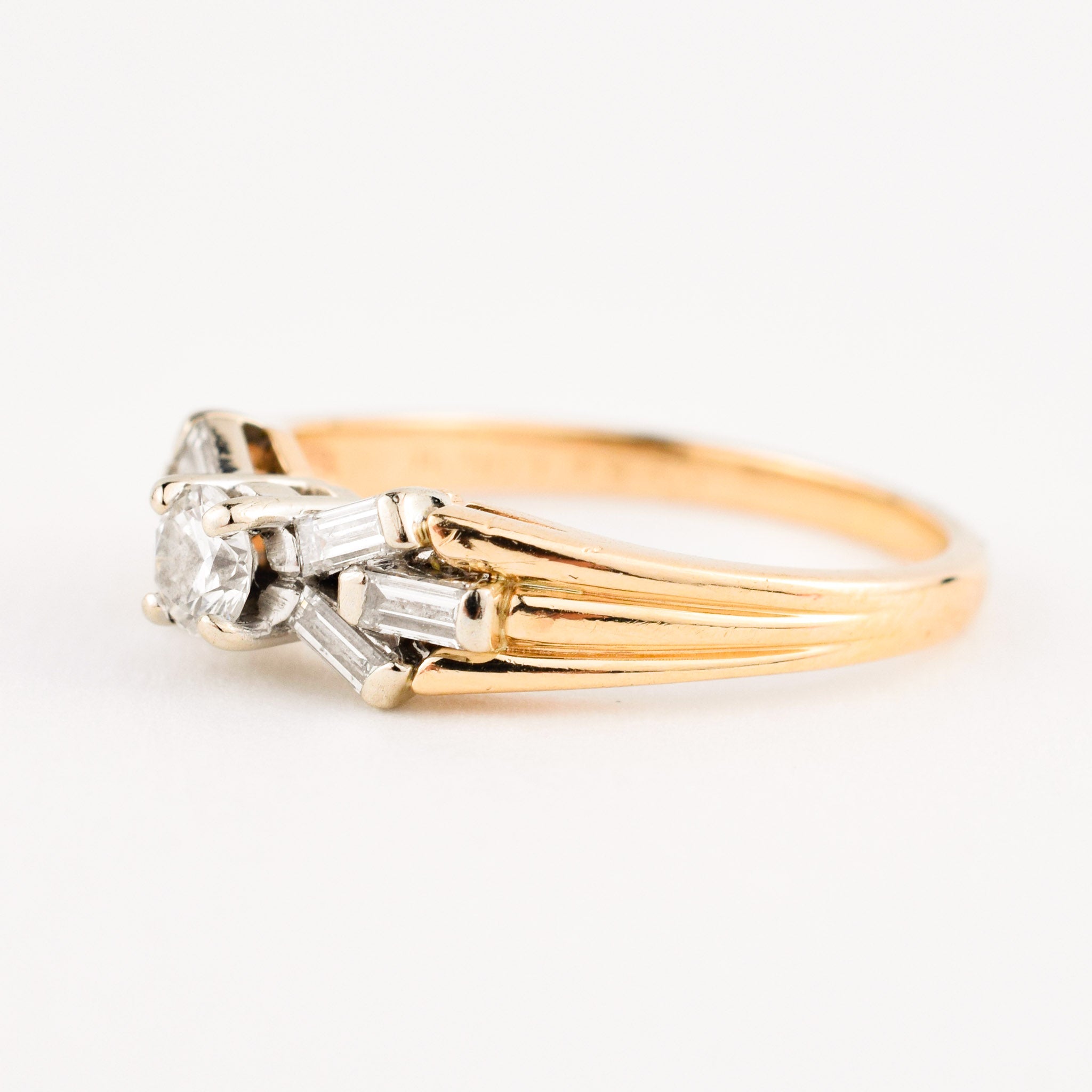 vintage engagement ring with baguette diamonds on band