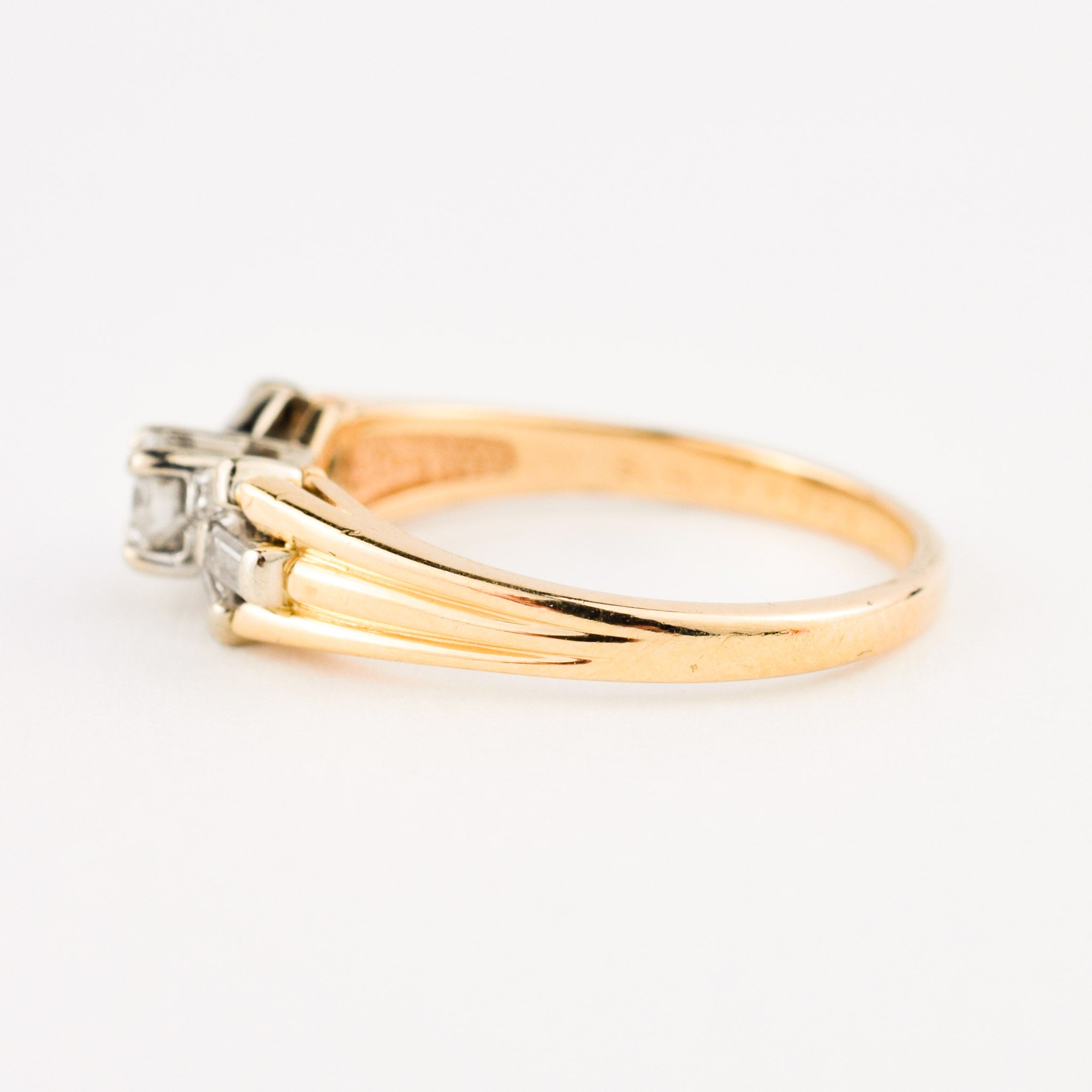 vintage engagement ring with baguette diamonds on band