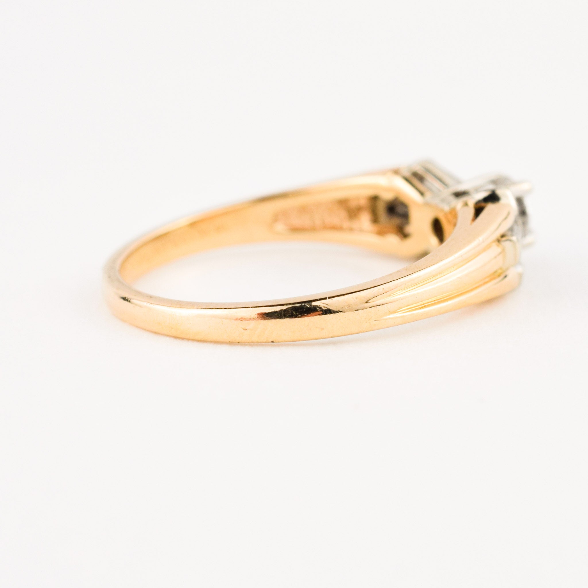 vintage engagement ring with baguette diamonds on band