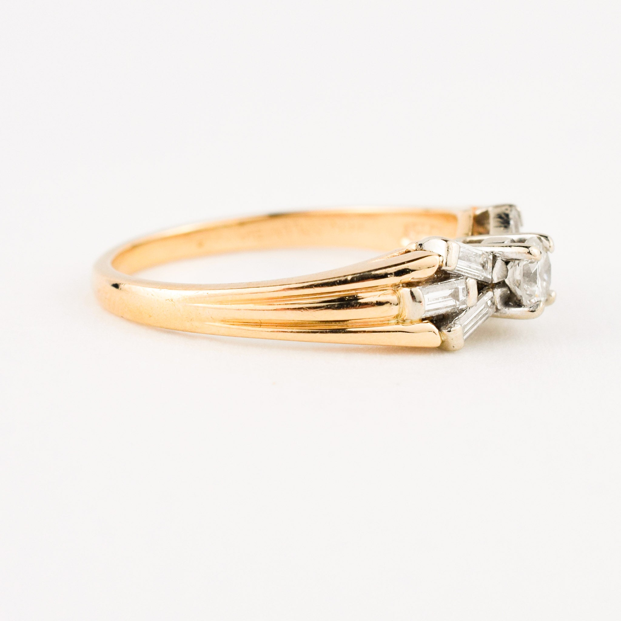vintage engagement ring with baguette diamonds on band