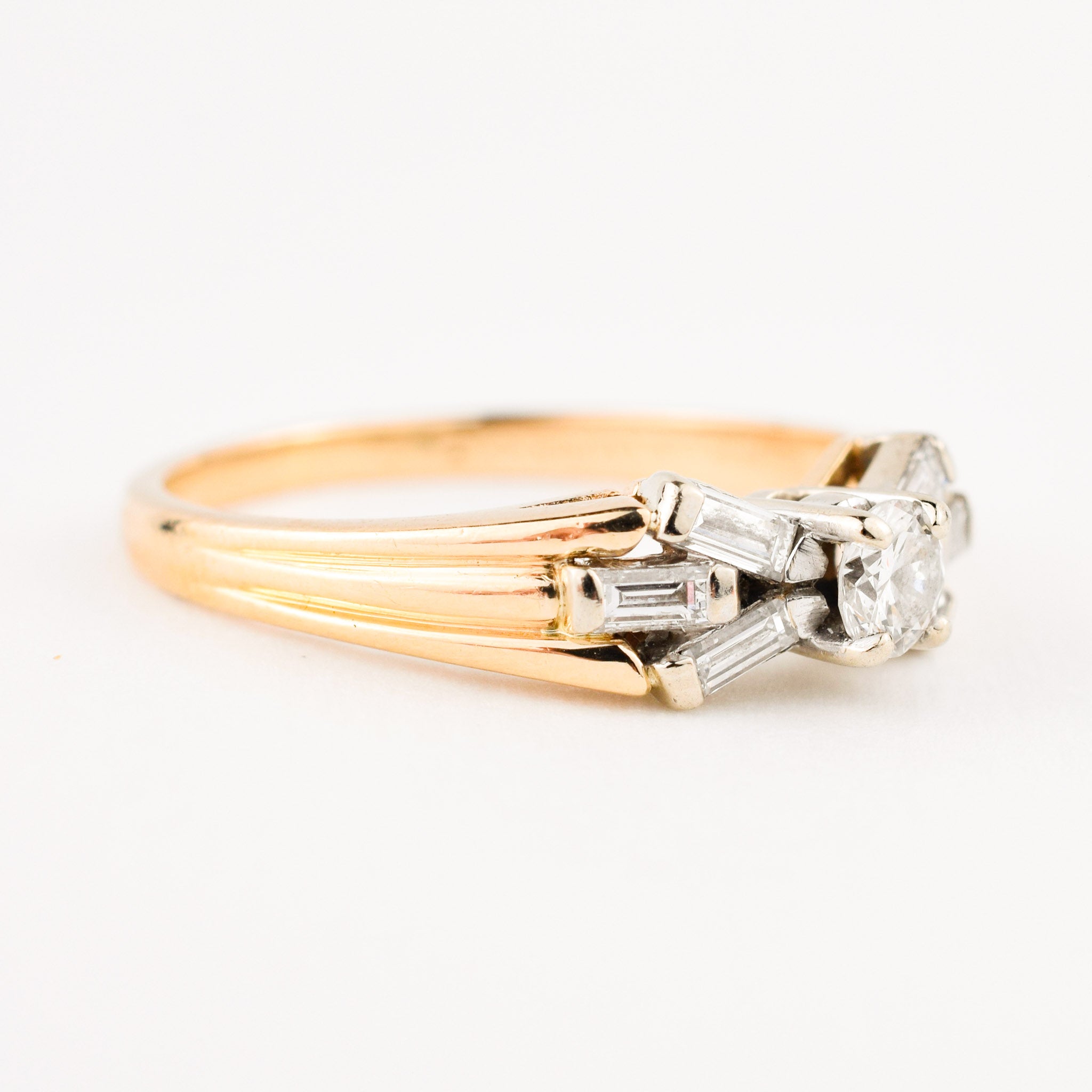 vintage engagement ring with baguette diamonds on band