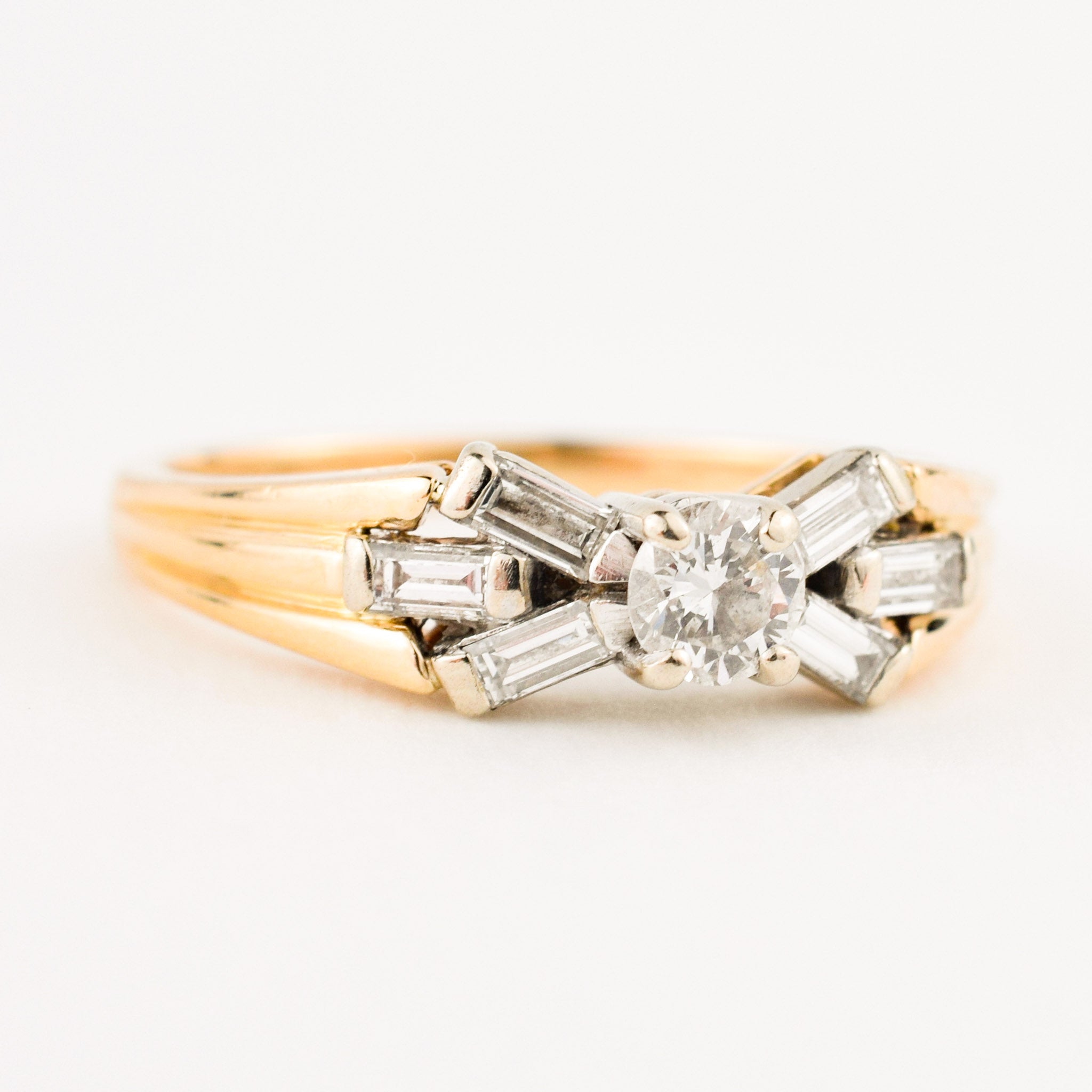 vintage engagement ring with baguette diamonds on band