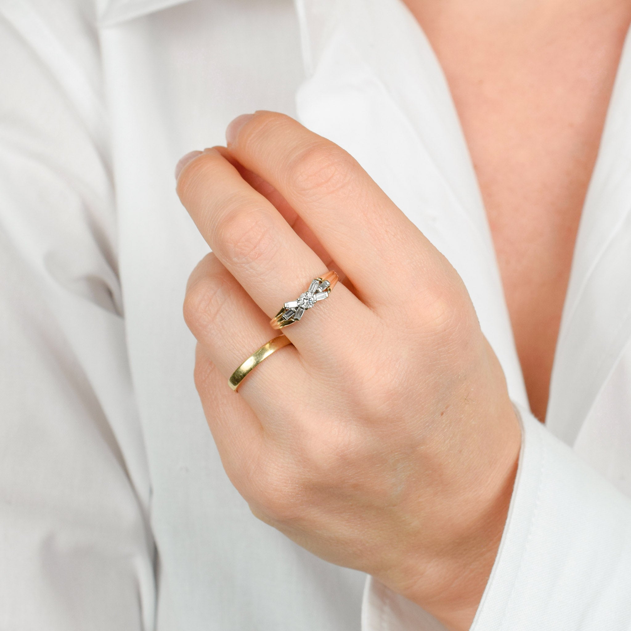 vintage engagement ring with baguette diamonds on band