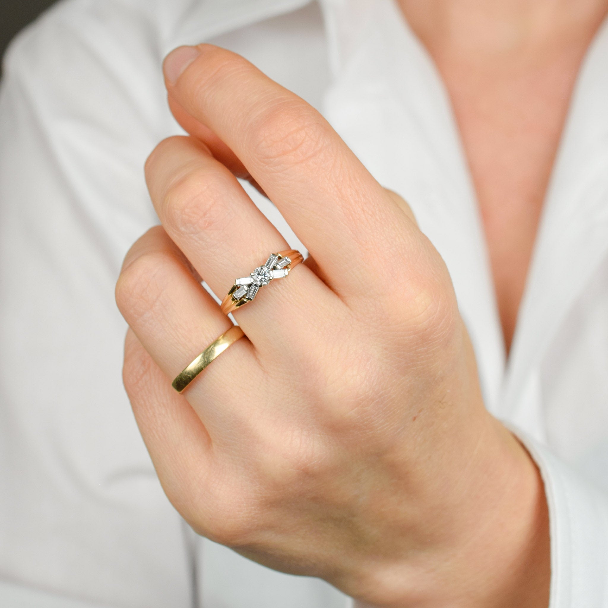 vintage engagement ring with baguette diamonds on band