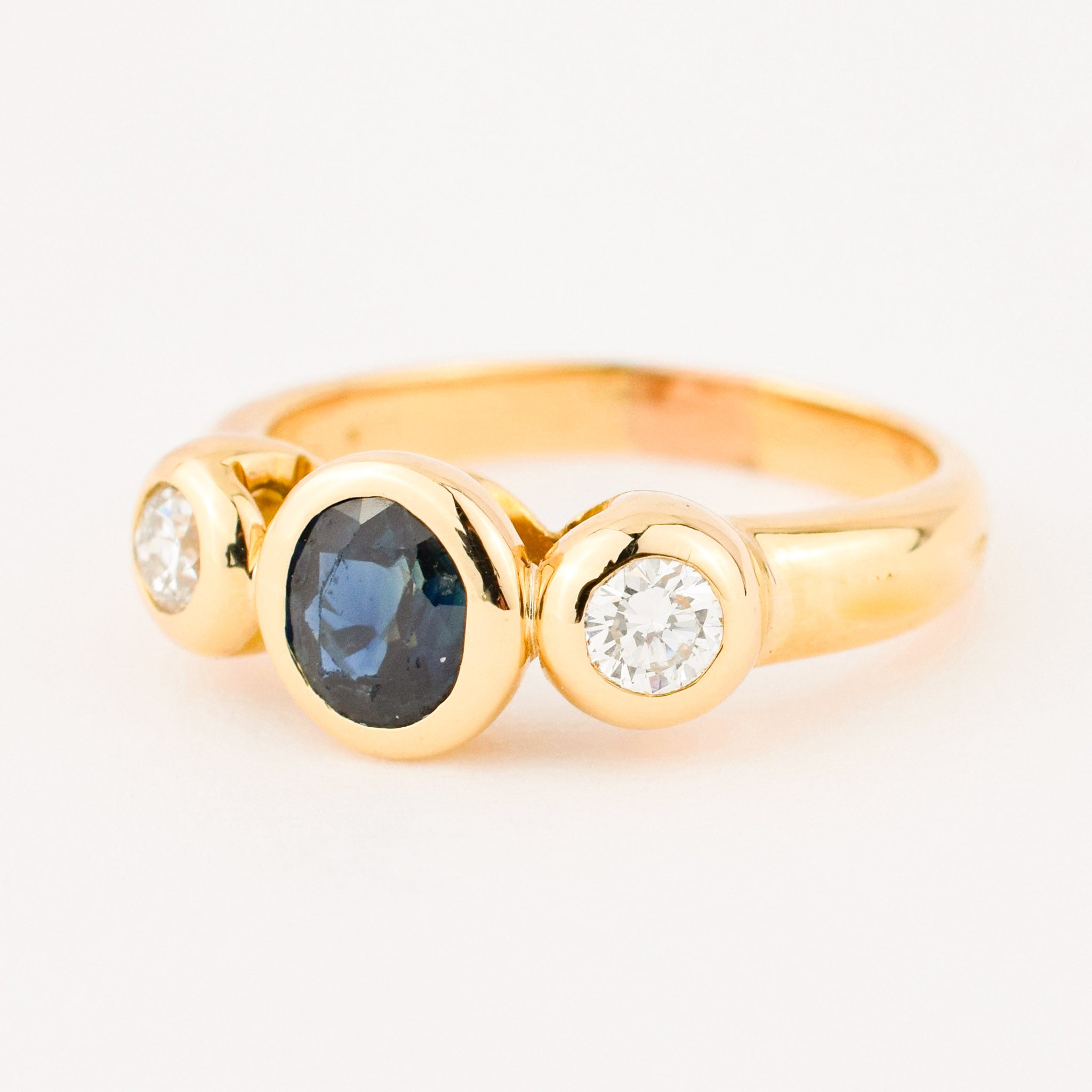bezel set diamond and sapphire trilogy ring