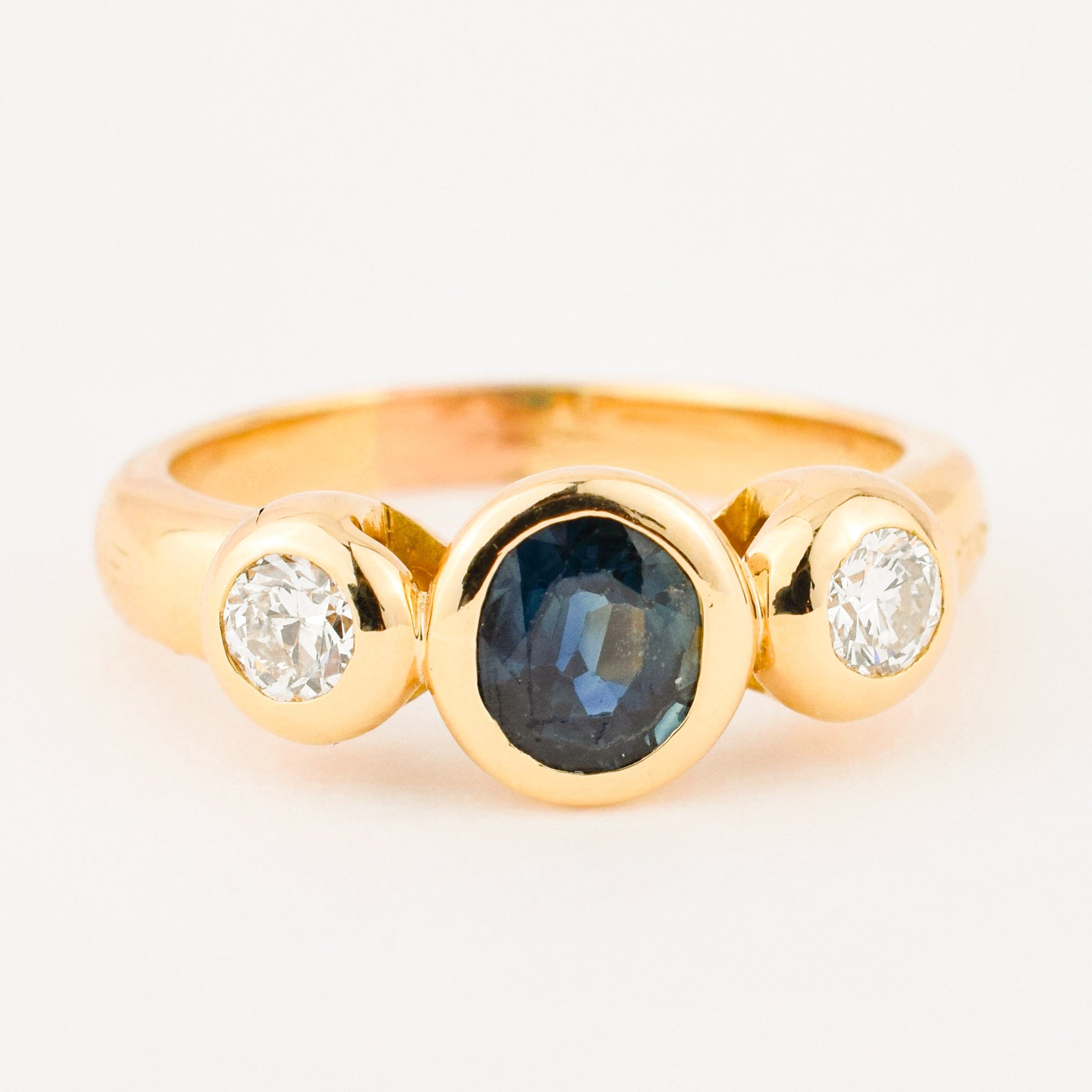 bezel set diamond and sapphire trilogy ring