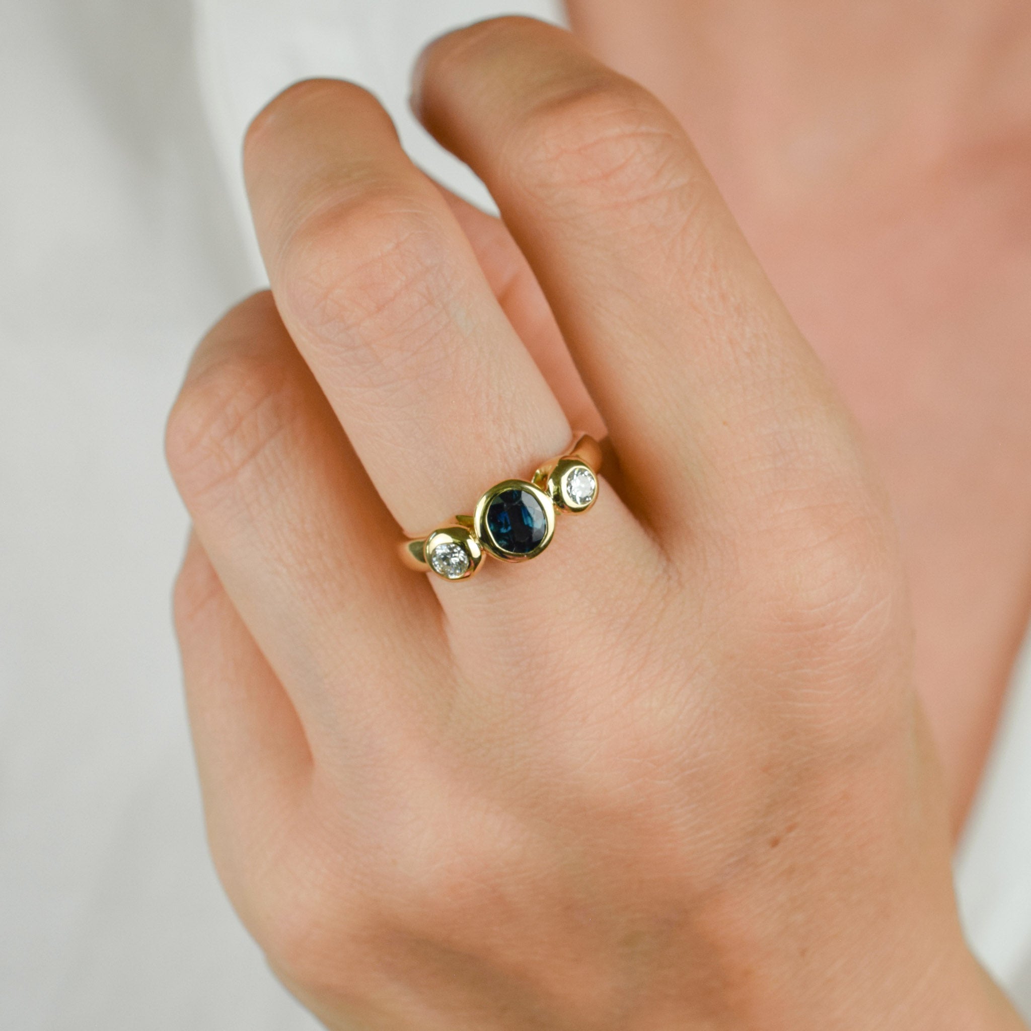 bezel set diamond and sapphire trilogy ring