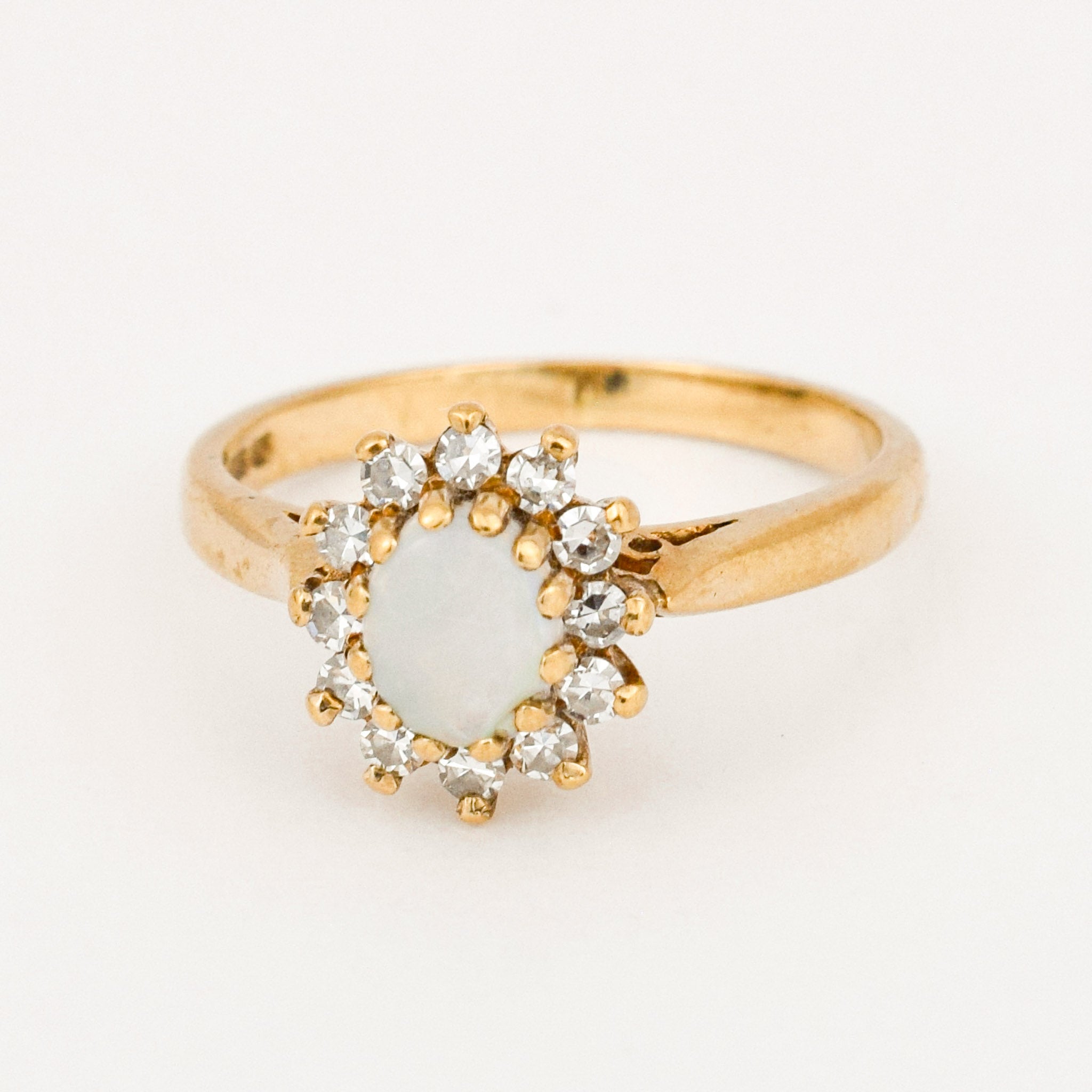 vintage gold opal and diamond halo ring 