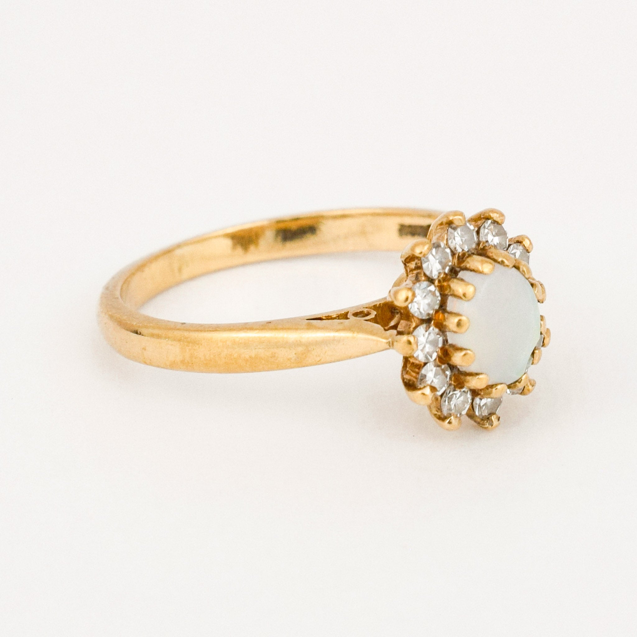 vintage gold opal and diamond halo ring 
