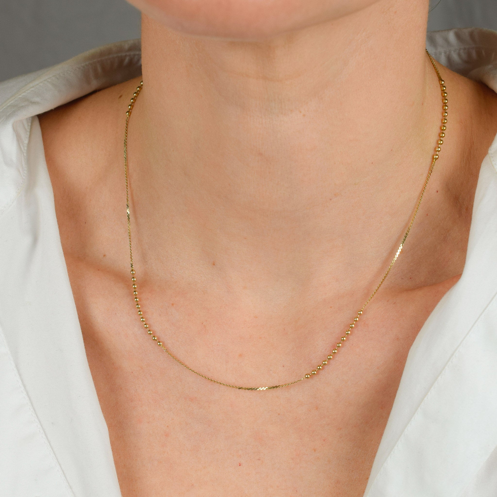 vintage gold static ball necklace