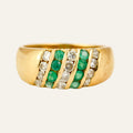Vintage 18k gold dome band with five diagonal channel-set rows of emeralds and diamonds.