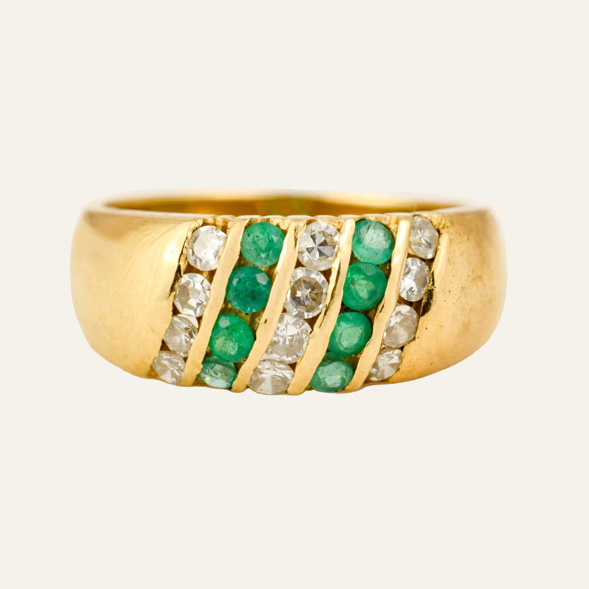 Vintage 18k gold dome band with five diagonal channel-set rows of emeralds and diamonds.