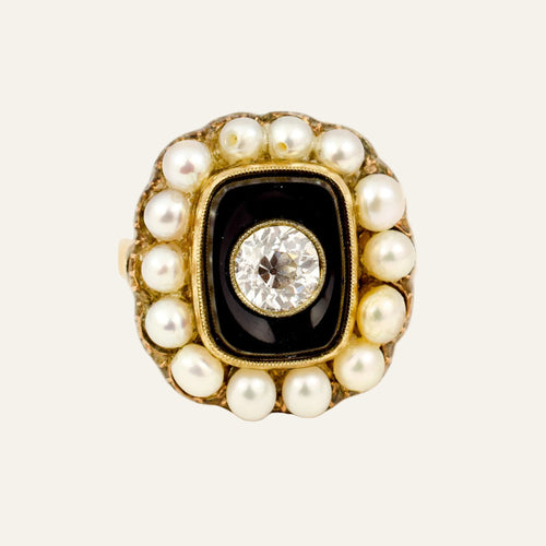 Victorian 10k gold mourning ring, cushion onyx panel with an old mine cut diamond centre and fourteen pearls surrounding.