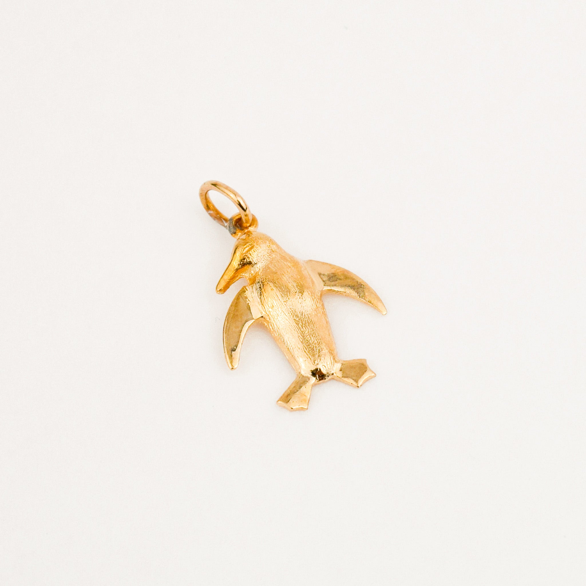 Gold penguin charm on sale