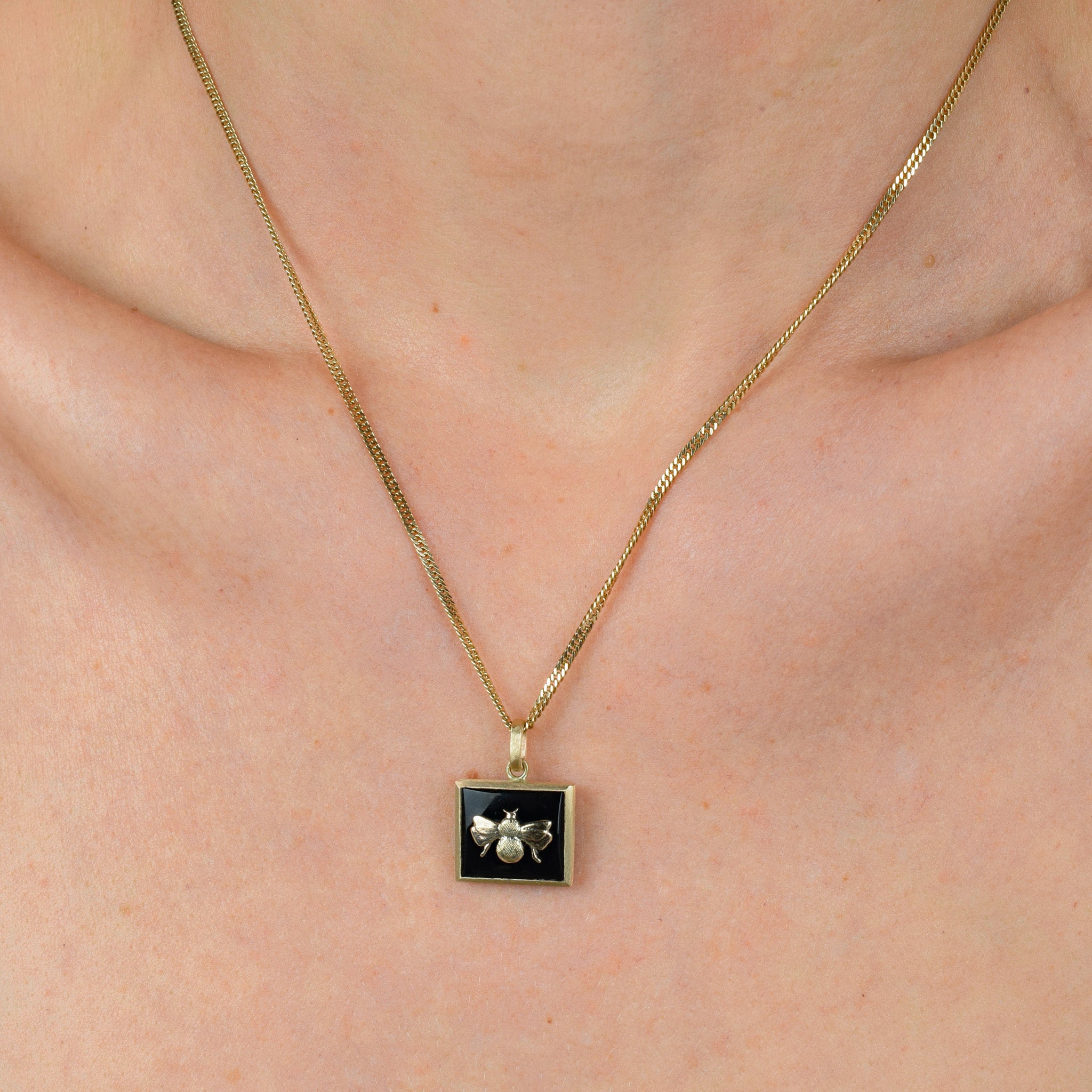 Bezel Set Onyx and Gold Bee Pendant