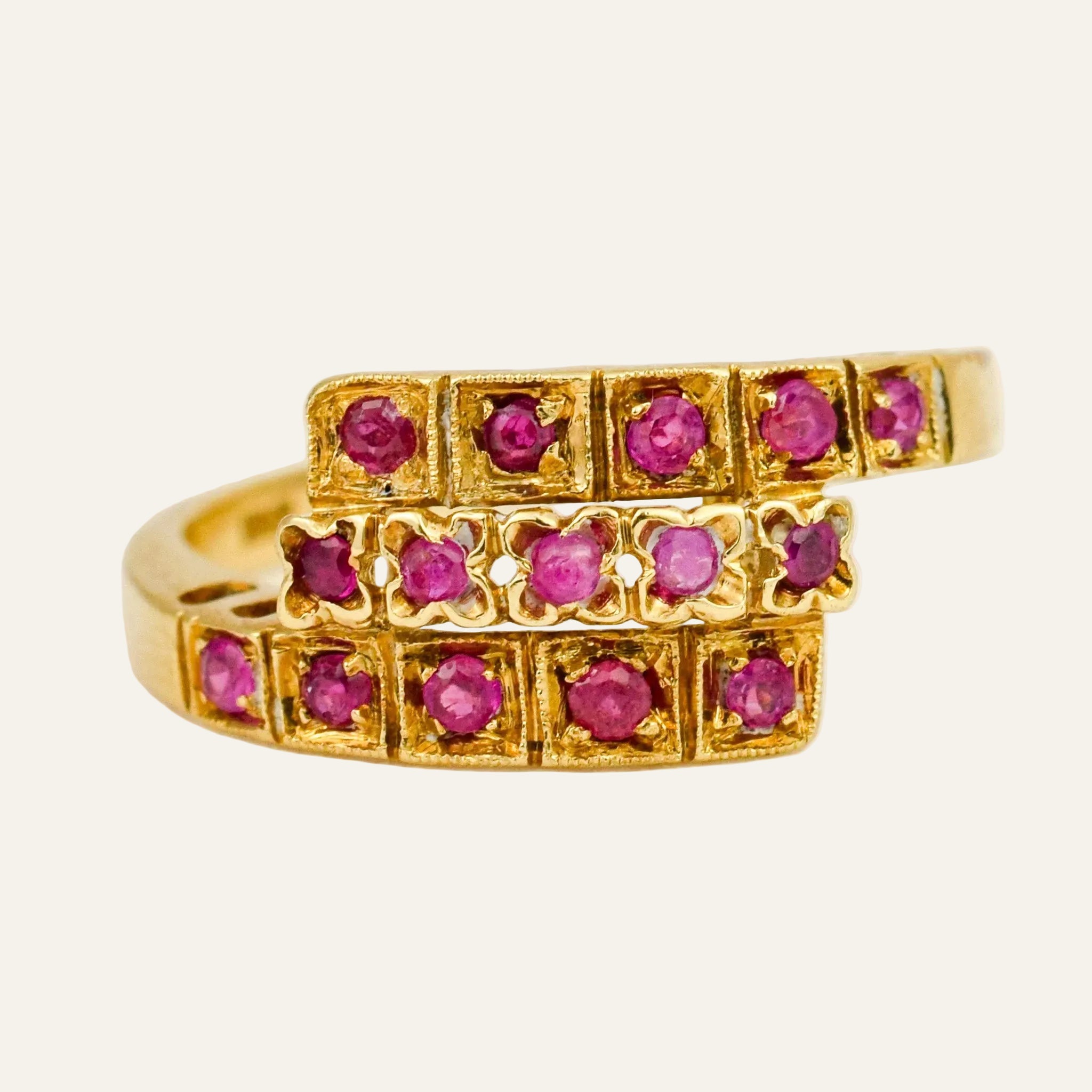 14k yellow gold ring with three stacked rows of round rubies in beaded square and scalloped floral settings