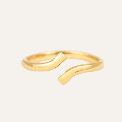 Vintage 14k gold bypass pinky ring, a plain open band with flat angled ends.