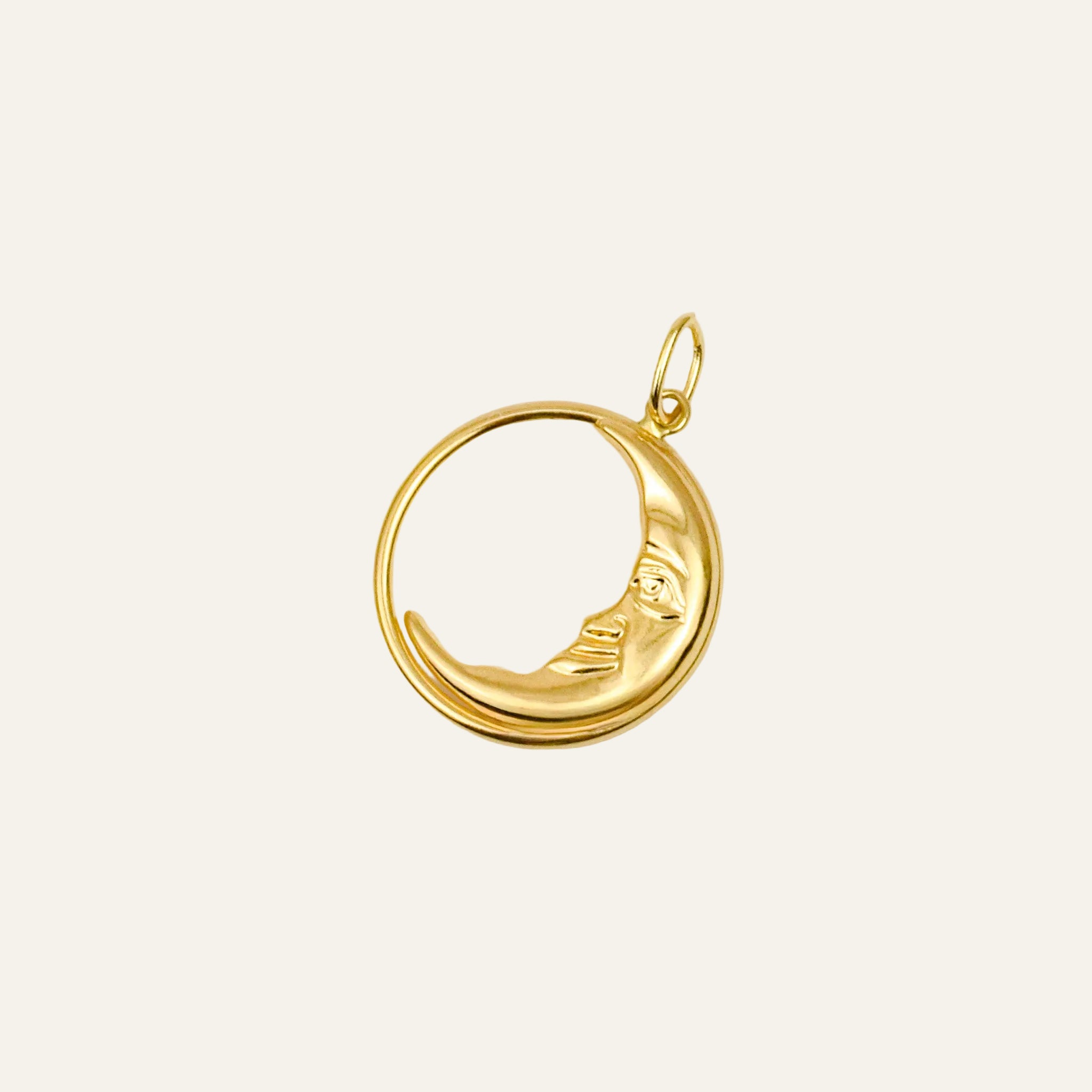 10k yellow gold crescent moon pendant with a sleeping face, curve nestled inside an open circle
