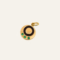 Vintage 10k gold pendant converted from a cufflink, with a black enamel ring and three emeralds.
