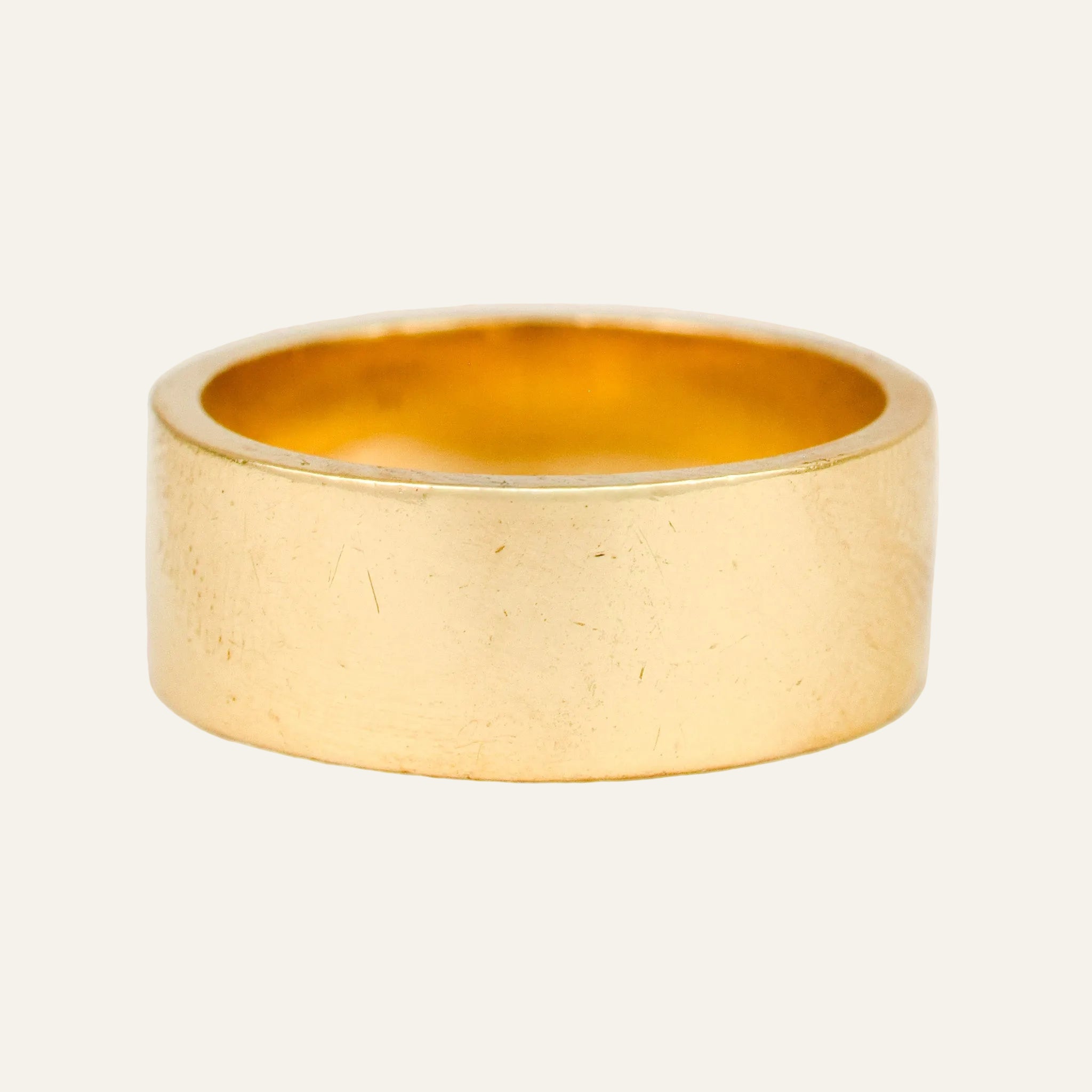 Wide flat high-polished 10k yellow gold cigar band with soft surface patina