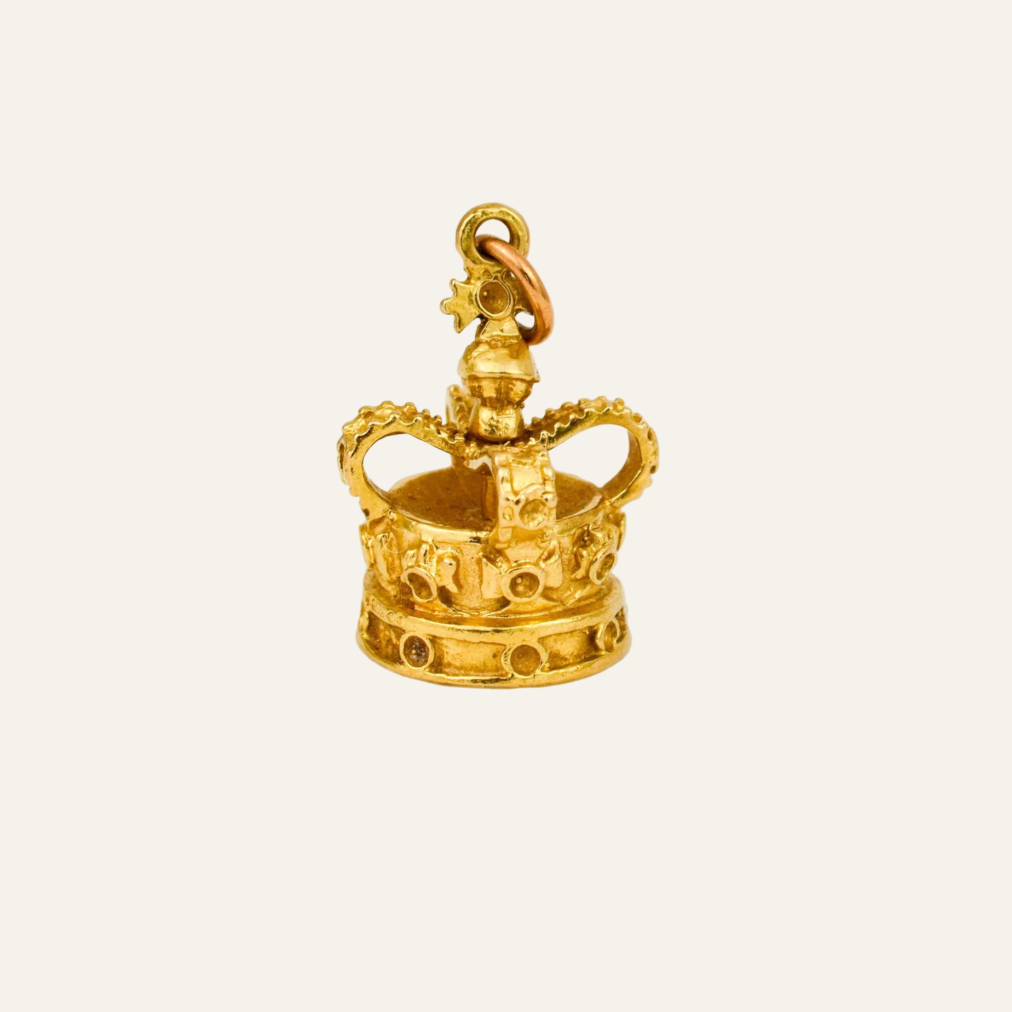 Miniature 9k gold crown charm worked in the round, arched hoops, beaded rim, and openwork band of arches