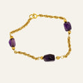 Vintage 14k gold rope chain bracelet with deep purple amethyst stones set at intervals.