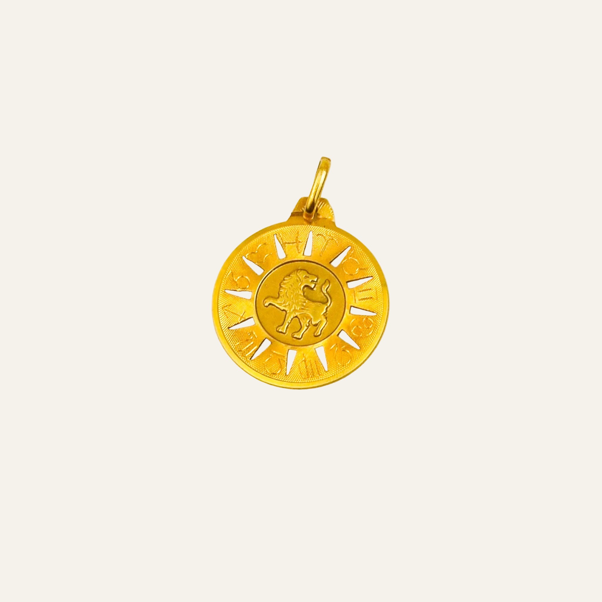Round 10k gold Leo zodiac pendant with a central lion framed by all twelve zodiac symbols and radiating sun rays
