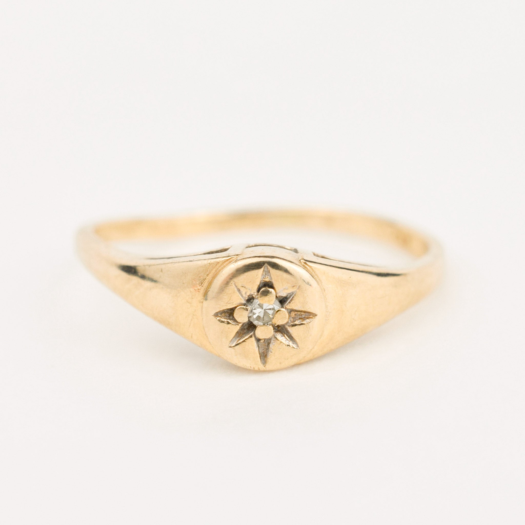 gold diamond starburst pinky signet ring 