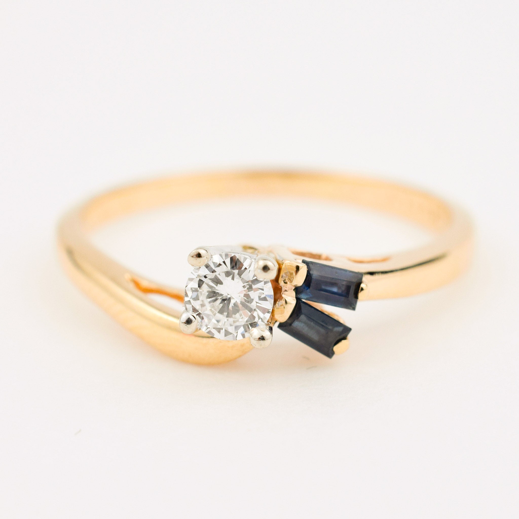vintage gold diamond engagement ring with two sapphires