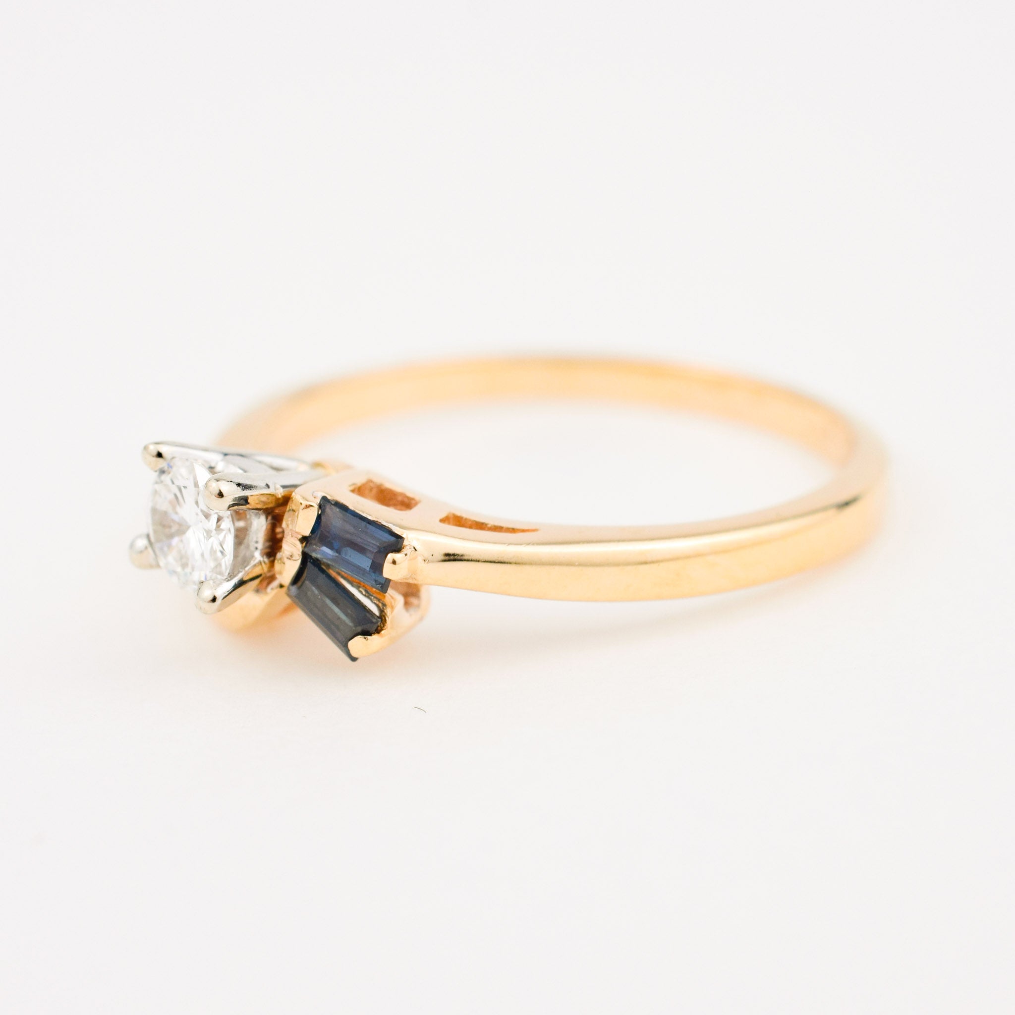 vintage gold diamond engagement ring with two sapphires